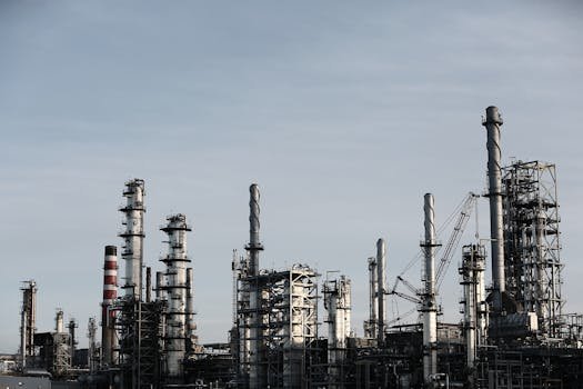 dirty-industry-stack-factory-2391 Skyline view of an industrial factory with tall chimneys against a clear sky.